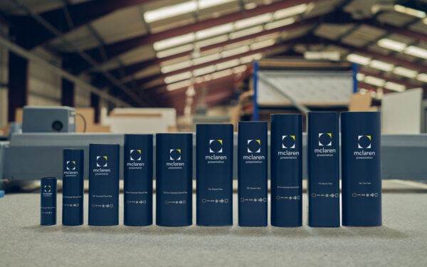 Ten different sized round and shaped presentation tubes on display in the McLaren factory